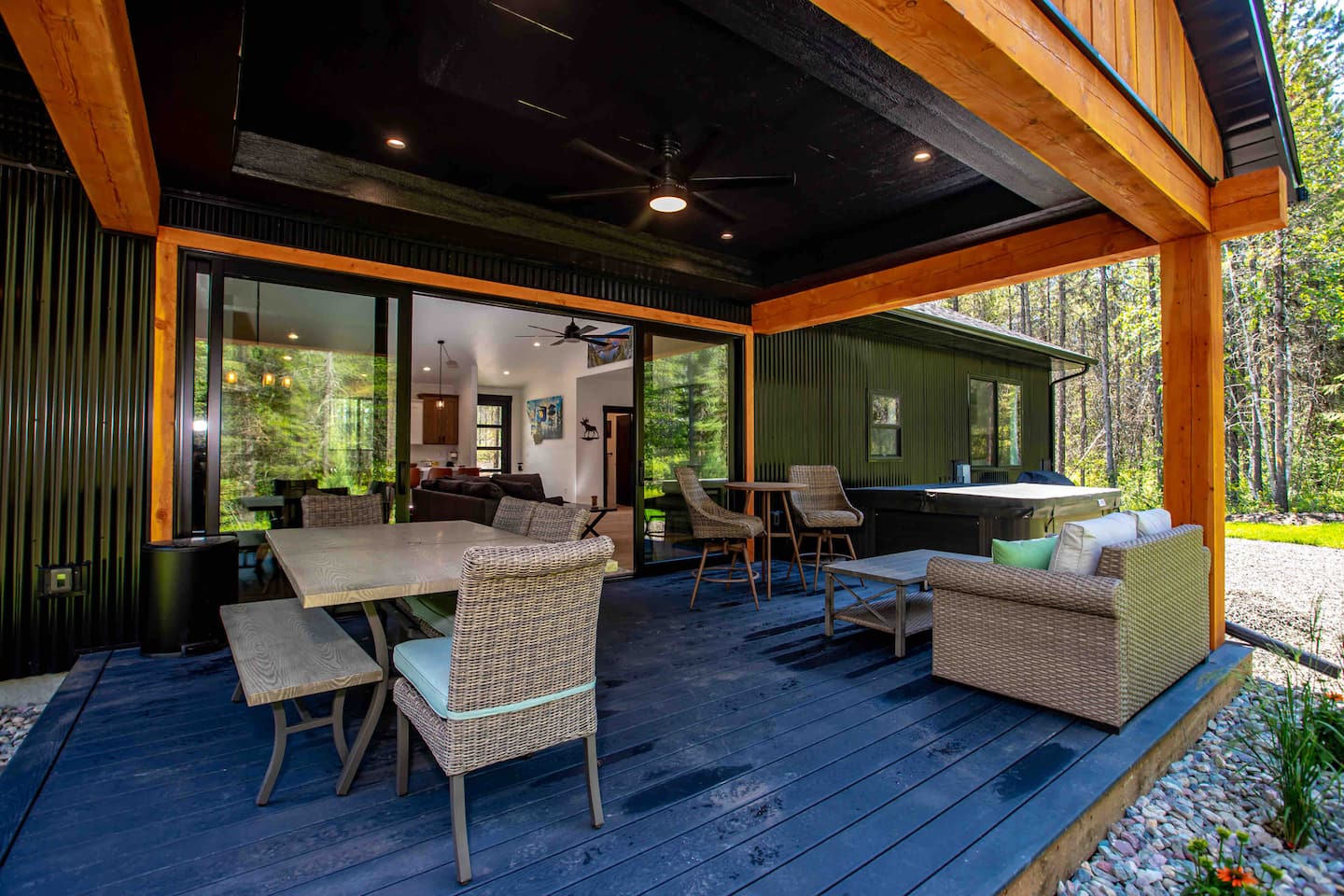 Covered outdoor living area and private hot tub at West Glacier Luxury Getaway